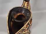 a black and gold vase with a bird on it