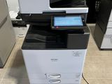 a multi - function printer sitting on top of a cabinet
