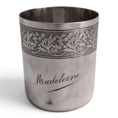 a silver cup with a design on it