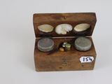 a small wooden box that has some coins inside of it