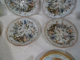 several plates and bowls are sitting on a white table