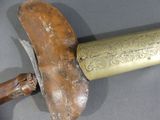 a knife that is laying on top of a piece of wood