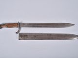 pair of two knives on a white surface with a knife in the middle