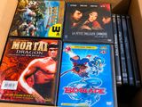 many dvds in a box that are sitting on a table