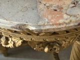 a gold clock with a marble face on it
