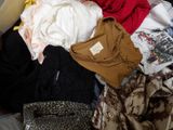 a pile of clothes on a bed in a room