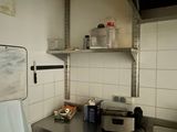 a small kitchen with a sink and a refrigerator in it