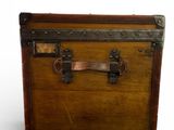 a small wooden trunk with a metal handle on a white background