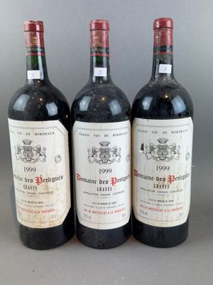 three bottles of red wine are lined up on a table