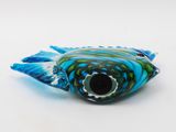 a glass fish that is sitting on a white surface