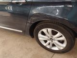 a car that has been painted blue and is parked in a garage