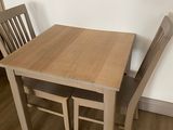 a small table and two chairs in the corner of the room