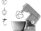 a silver mixer with a metal bowl and a whisk attachment