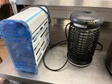 a small air purifier sitting on a counter next to a large air conditioner