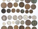 a group of old coins on a white surface