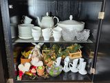 a cabinet with a lot of dishes and cups on it
