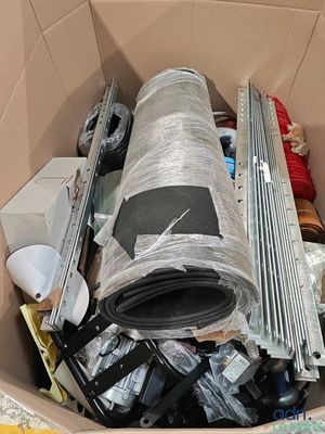 a cardboard box filled with assorted electronics and other items