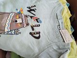 a box full of baby clothes that are in a box