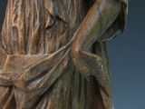 bronze statue of a woman holding a basket of flowers in her hands