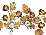 a gold leaf wall decoration with a clock on it