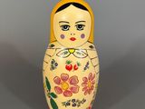 a small wooden matry doll with flowers on it