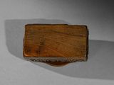 a small wooden box with a handle on a table