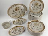 a lot of plates and bowls that are sitting on a table