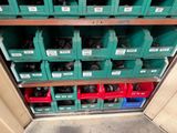 many green bins and red bins on the shelves
