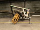 a pile of wood and metal on the ground in a warehouse