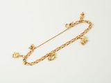 a gold necklace with charms and a chain on a white background