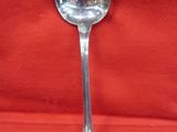 a spoon that is sitting on a red cloth