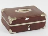 a brown suitcase sitting on a white surface