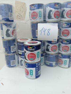 many cans of blue paint on a white table