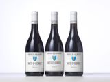 three bottles of wine sitting on top of a table next to each other