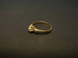a close up of a gold ring on a black surface
