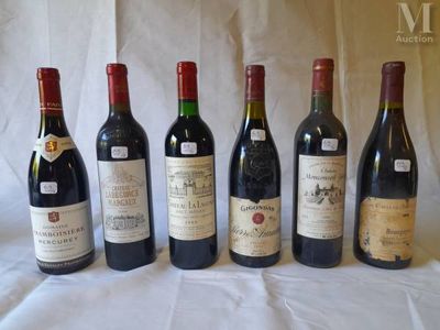 several bottles of wine are lined up on a table