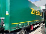 a large green semi truck parked in a parking lot