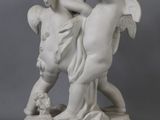 a statue of two children playing with each other