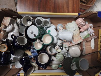 a cardboard box filled with many different types of pottery