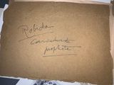 a piece of cardboard with writing on it sitting on a table