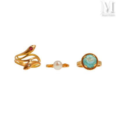 a pair of gold rings with a turquoise stone and a pearl