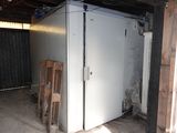 a refrigerator that is in the middle of a room