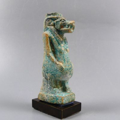 an image of a statue of a horse on a wooden base