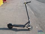 a scooter that is parked on the side of the road