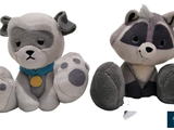 two stuffed animals sitting next to each other on a white surface