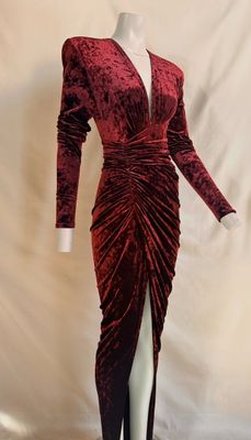 a mannequin dress with a red velvet wrap and long sleeves