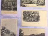 several old postcards of different types and sizes are on a table