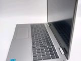 a silver laptop computer sitting on top of a white table