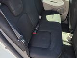 the back seats of a white car with a black seat belt