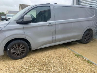 a silver van parked in front of a garage door